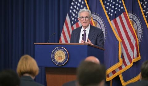 Fed holds interest rates steady, flags rising trade risk
