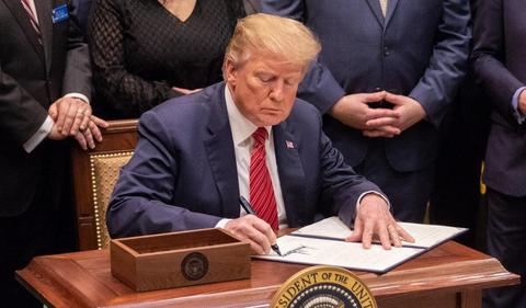 Trump signs order pausing a ban on foreign bribery