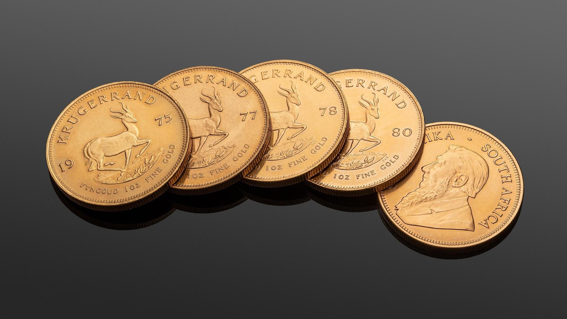 Gold slips below record highs as risk appetite returns