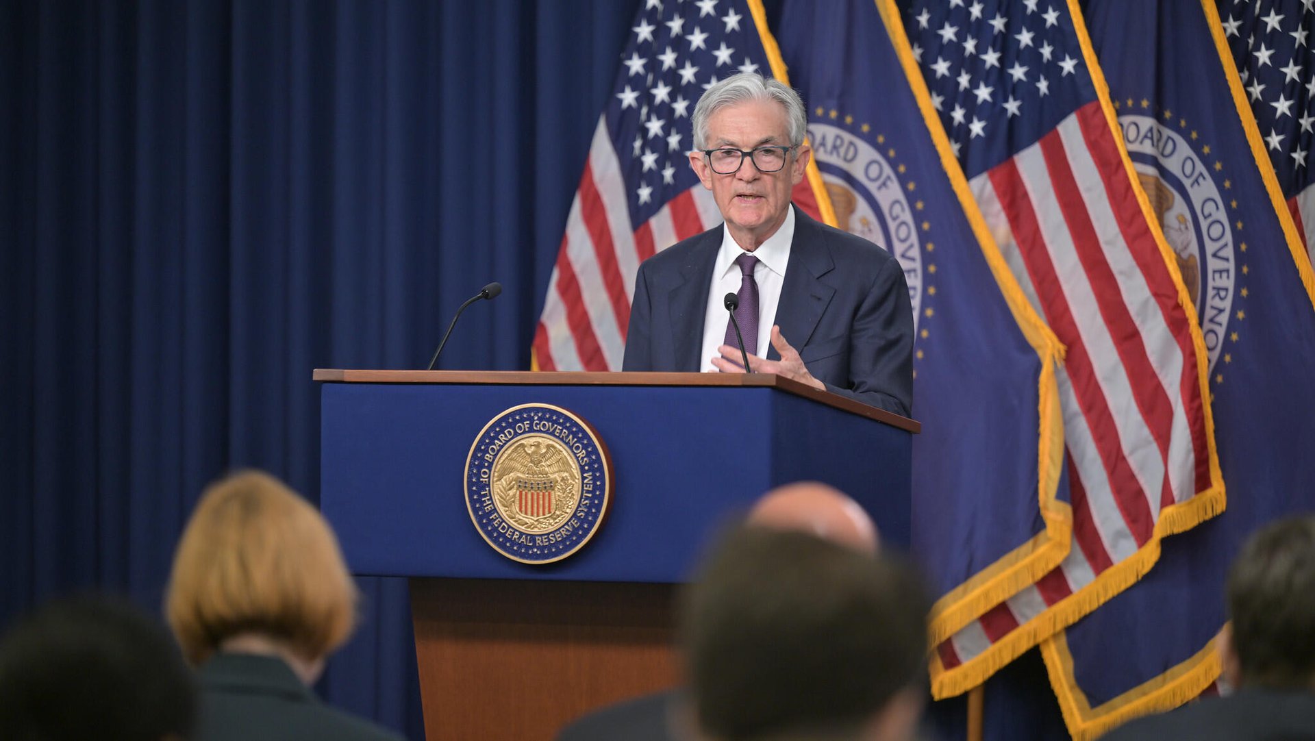 Fed holds interest rates steady, flags rising trade risk